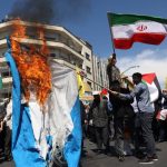 Iranians burn Israeli flag